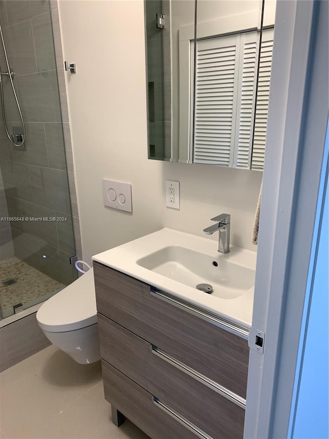 bathroom featuring vanity, a shower with shower door, toilet, and tile patterned flooring