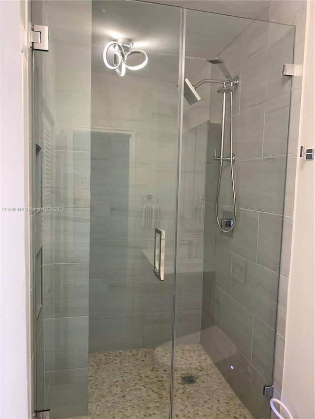 bathroom with a shower with door