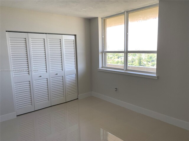 unfurnished bedroom with a closet