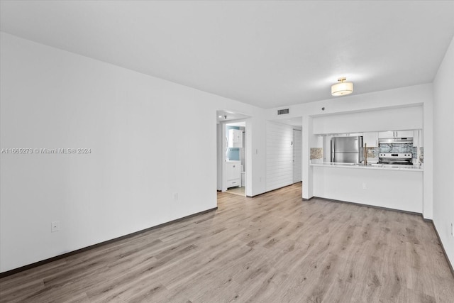 unfurnished living room with light hardwood / wood-style flooring