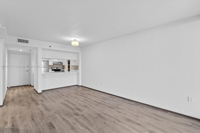 unfurnished living room featuring light hardwood / wood-style flooring