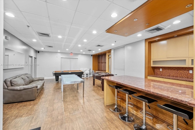 game room featuring a drop ceiling, light hardwood / wood-style floors, bar area, and billiards