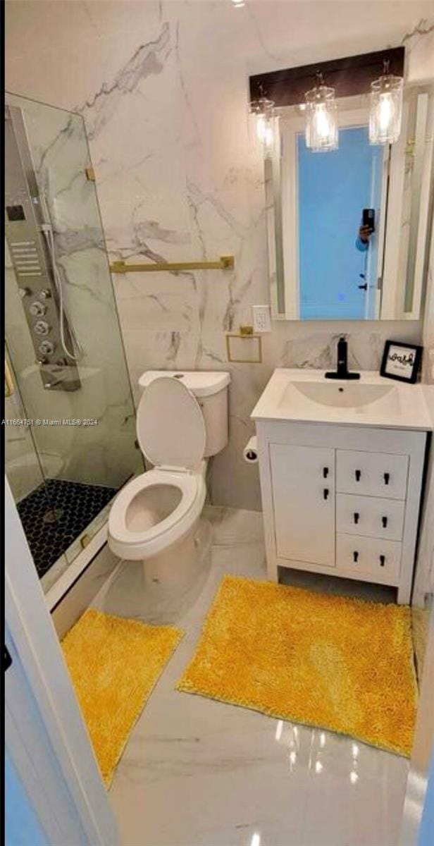 bathroom featuring tile walls, vanity, toilet, and a shower