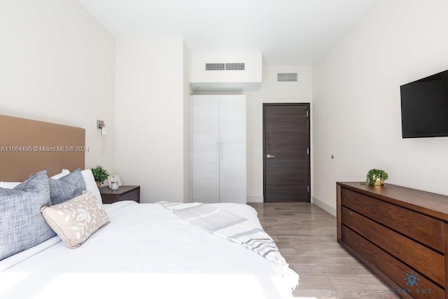 bedroom featuring light wood-type flooring and a closet