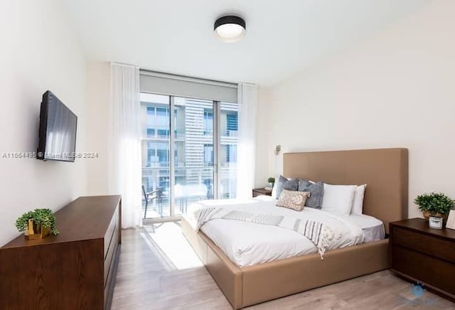 bedroom with access to outside and light hardwood / wood-style flooring