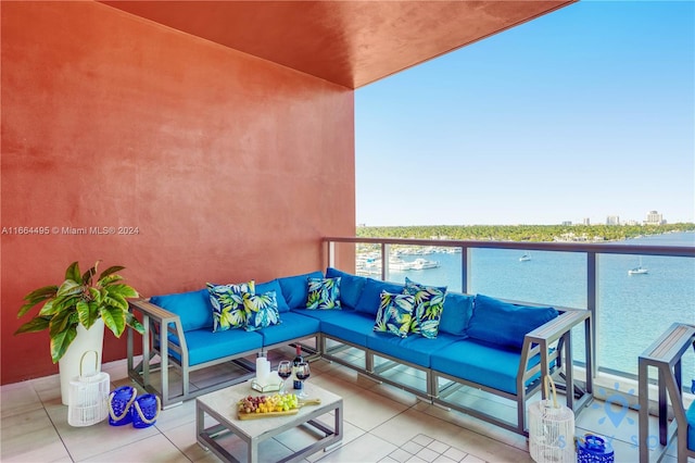 balcony with outdoor lounge area and a water view