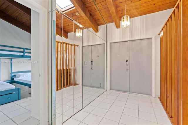 foyer entrance with wooden ceiling, a chandelier, and tile patterned floors