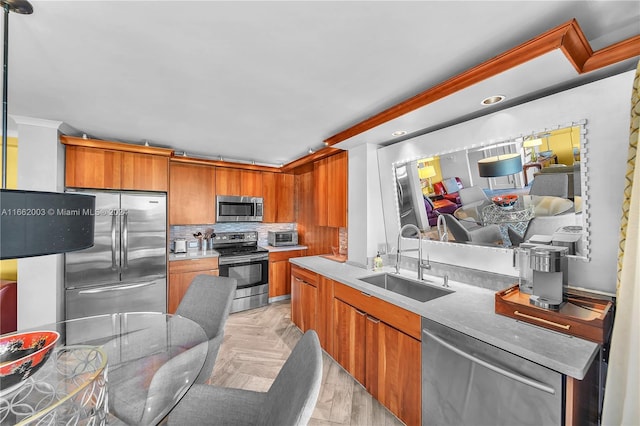 kitchen featuring backsplash, appliances with stainless steel finishes, light parquet floors, and sink