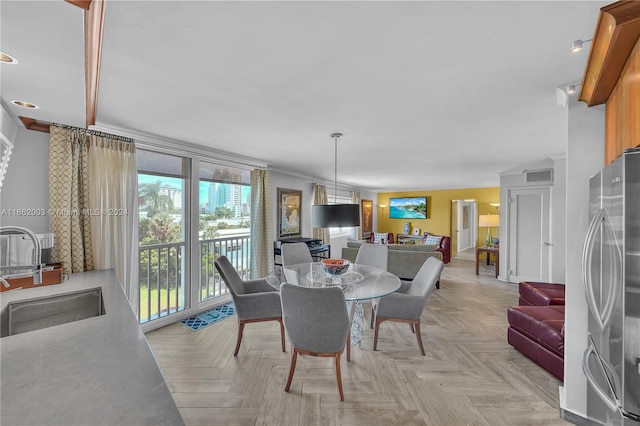 dining room featuring light parquet floors and sink