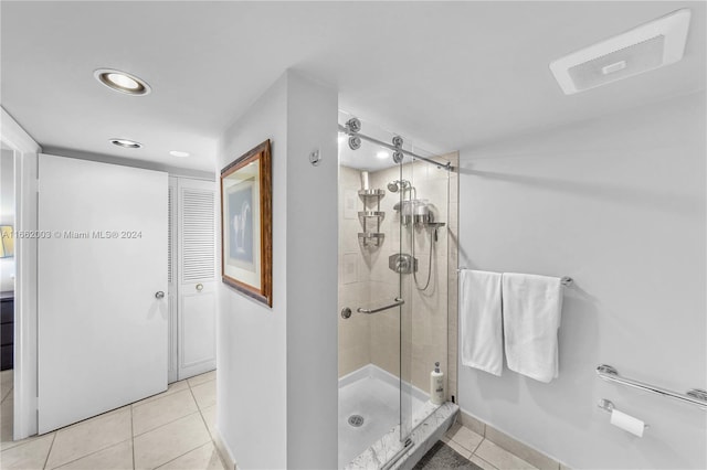 bathroom with walk in shower and tile patterned flooring