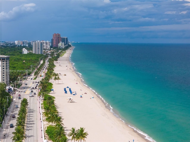 aerial view featuring a view of the beach and a water view