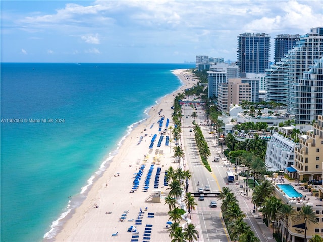 birds eye view of property featuring a beach view and a water view