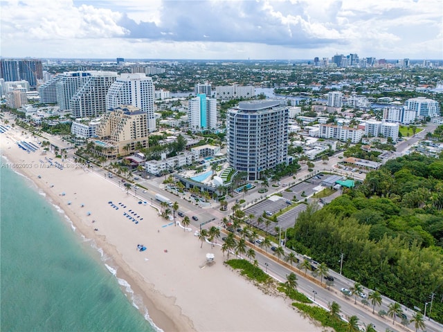 bird's eye view featuring a water view and a beach view