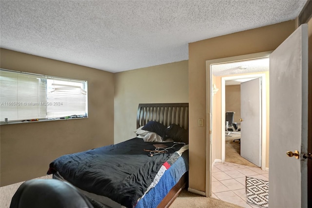 carpeted bedroom featuring a textured ceiling