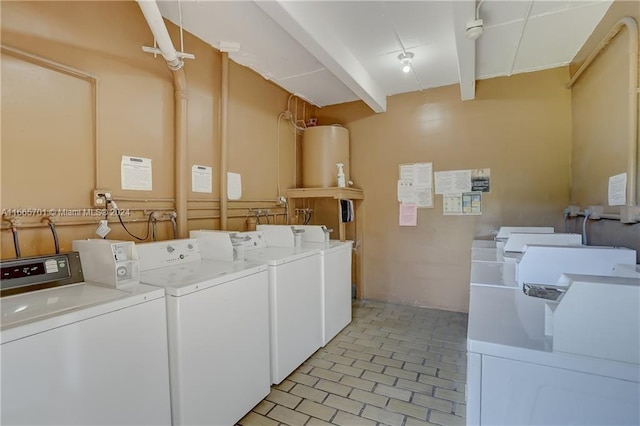 clothes washing area with water heater and washing machine and clothes dryer