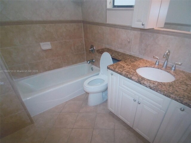 full bathroom with tile patterned floors, toilet, tile walls, shower / washtub combination, and vanity