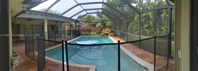 view of swimming pool with a lanai