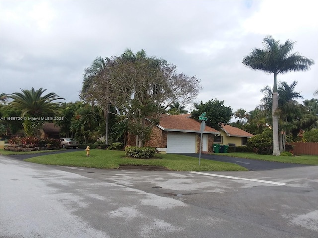 view of front facade with a garage and a front lawn