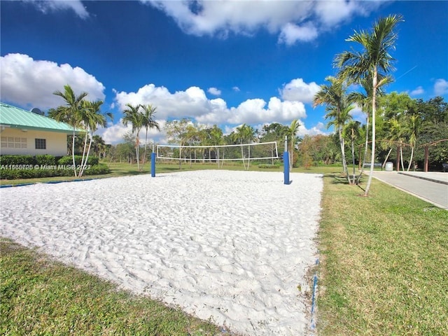 view of property's community featuring a lawn and volleyball court