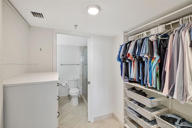 spacious closet featuring light tile patterned floors