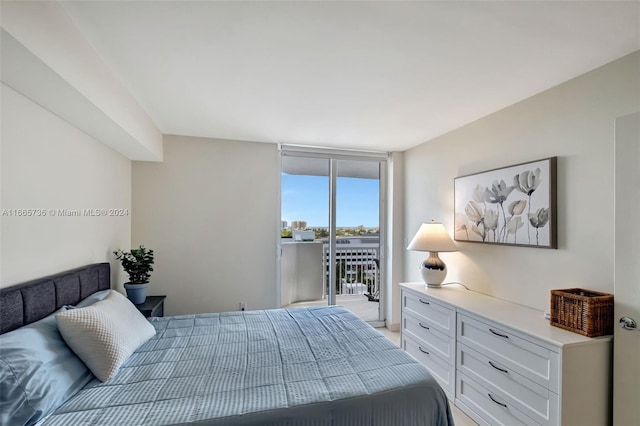 bedroom with access to outside and expansive windows