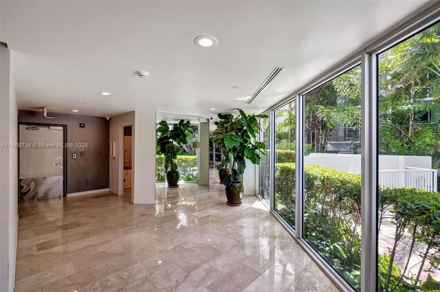 1621 Bay Rd Unit 1105, Miami Beach, FL 33139 - corridor featuring a wall of windows, marble finish floor, and recessed lighting