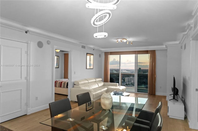 dining room featuring crown molding and light hardwood / wood-style flooring