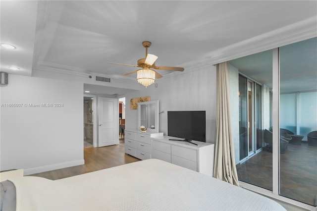 bedroom featuring ceiling fan, light hardwood / wood-style flooring, and expansive windows