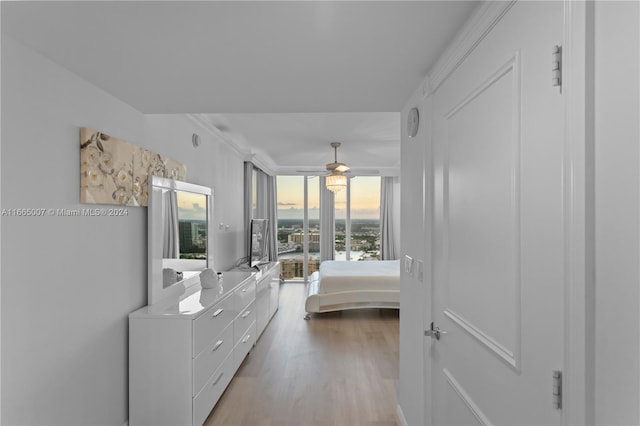 bedroom with light wood-type flooring and crown molding