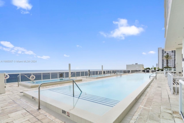 view of swimming pool featuring a water view