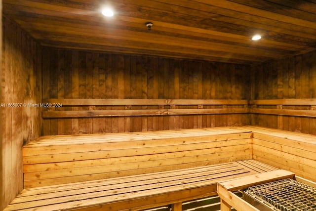 view of sauna featuring wooden walls and wood ceiling