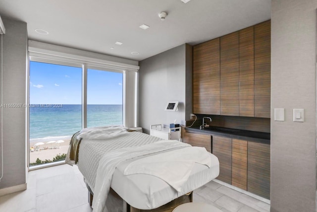 bedroom with a view of the beach and a water view