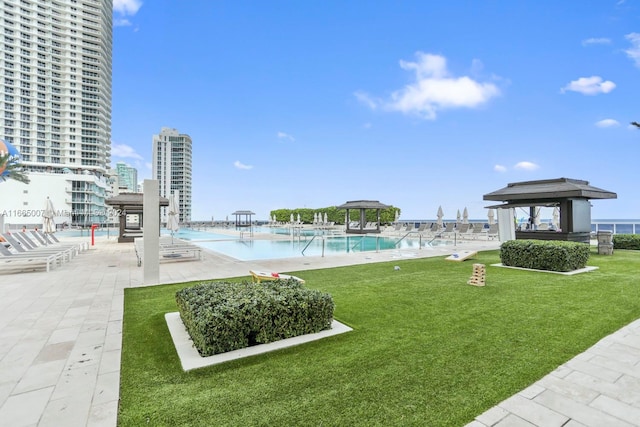 view of yard with a community pool and a patio