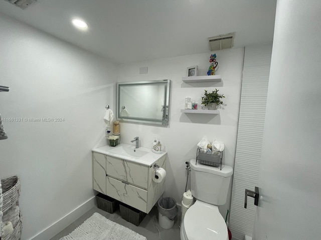 bathroom with vanity and toilet