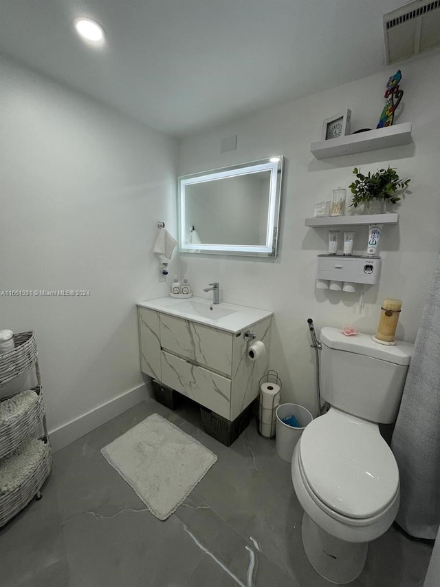 bathroom with vanity and toilet