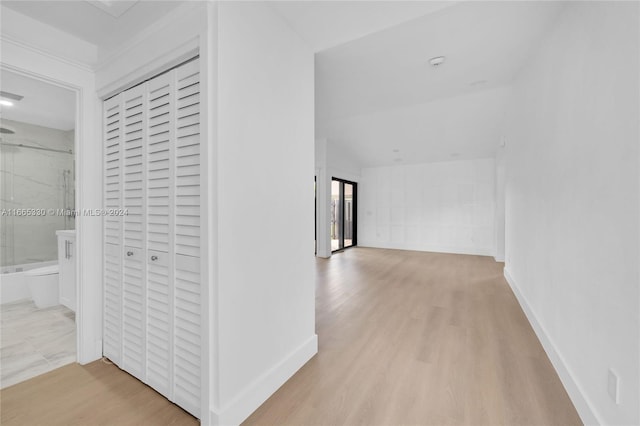 corridor with light hardwood / wood-style flooring