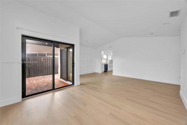 unfurnished living room with light hardwood / wood-style flooring and lofted ceiling