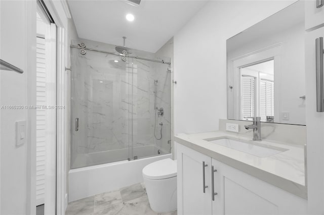 full bathroom featuring vanity, toilet, and combined bath / shower with glass door