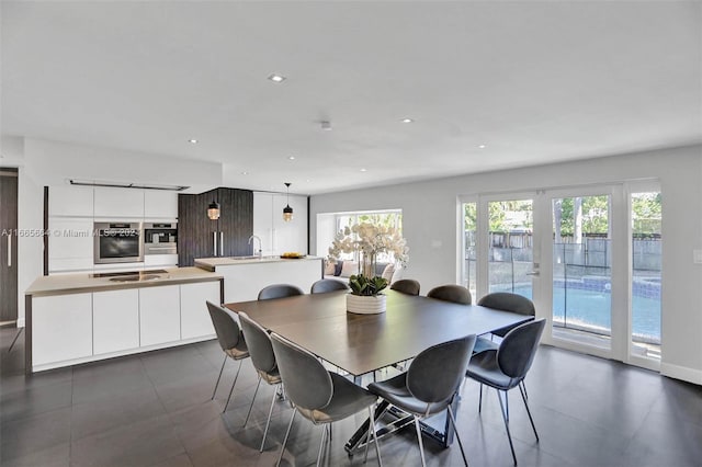 dining space featuring french doors and sink