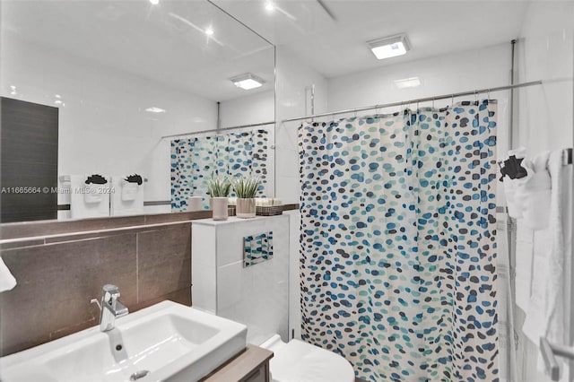 bathroom featuring vanity, a shower with door, and a healthy amount of sunlight