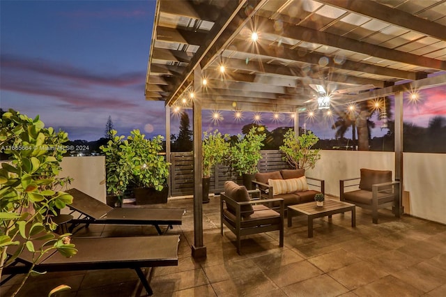 patio terrace at dusk with a pergola and outdoor lounge area