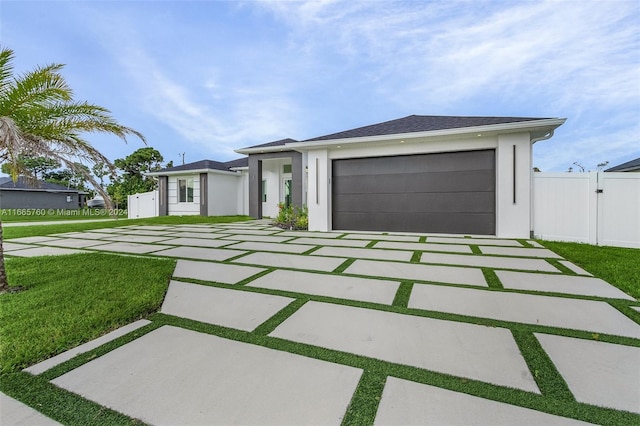 view of front of house with a front yard and a garage