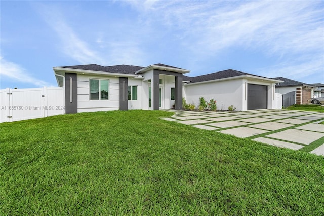 view of front of property featuring a front yard and a garage