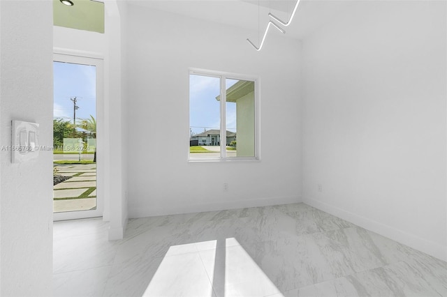 unfurnished room featuring a wealth of natural light