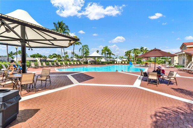 view of swimming pool with a grill, a gazebo, and a patio