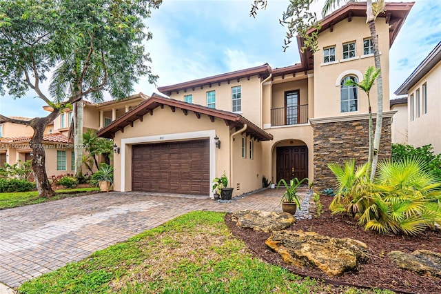 mediterranean / spanish home featuring a garage