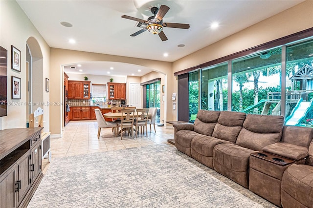 tiled living room featuring ceiling fan