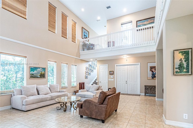 tiled living room featuring a towering ceiling