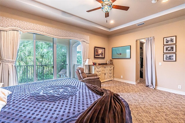 bedroom with ceiling fan, light carpet, a walk in closet, and access to exterior