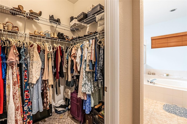 spacious closet with tile patterned floors